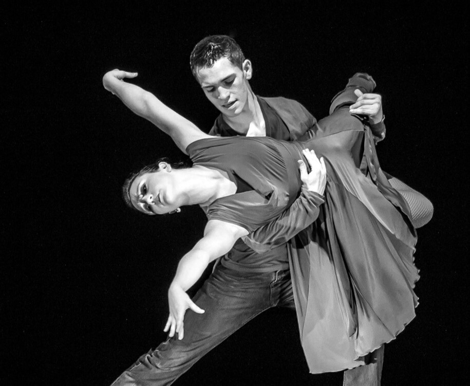 Black and white photo of two dancers on stage performing